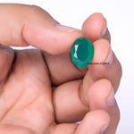 Holding a green onxy gemstone in hand