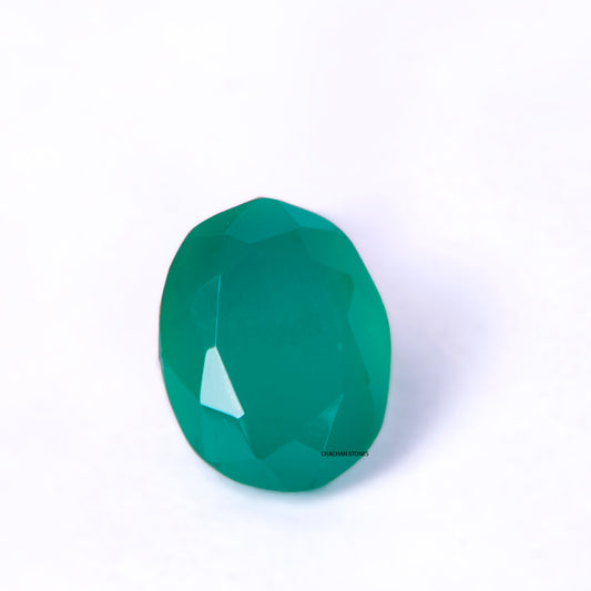 Faceted green gemstone on a white background