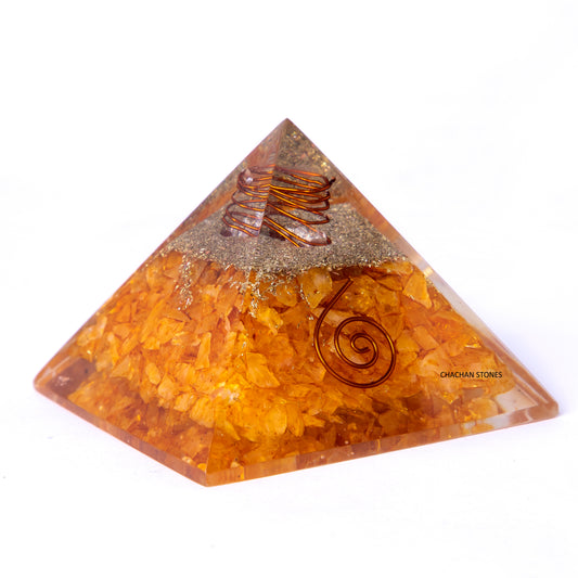 Pyramid-shaped crystal with spiral designs on a white background