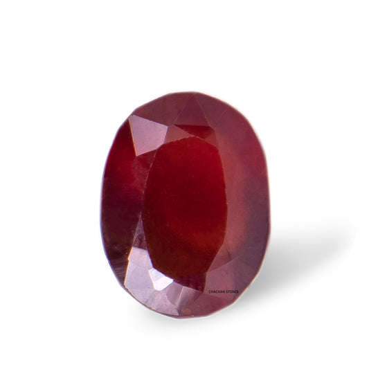 Faceted red gemstone on a white background