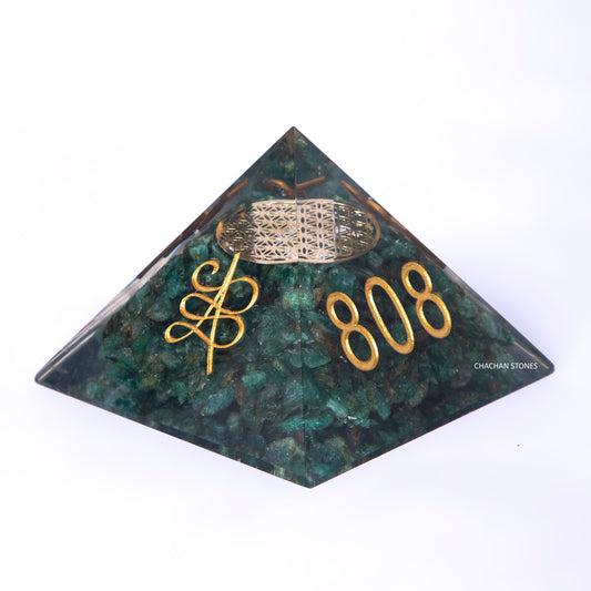Pyramid-shaped green stone with gold text and logo on a white background