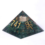 Pyramid-shaped object with gold text and symbols on a white background
