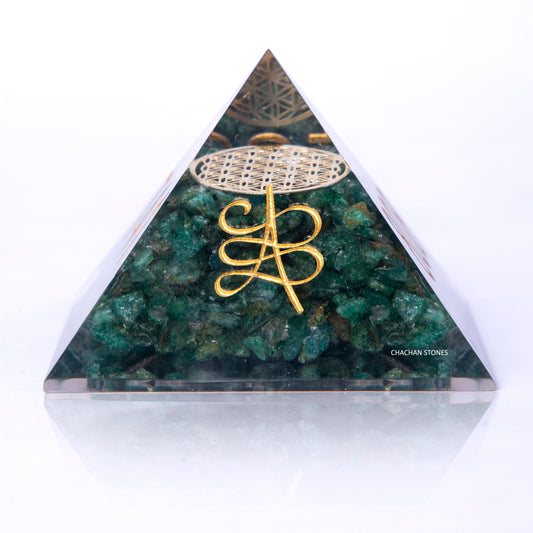 Triangular green stone pyramid with gold symbol on a white background