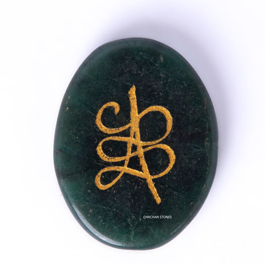 Green stone with gold symbol on a white background