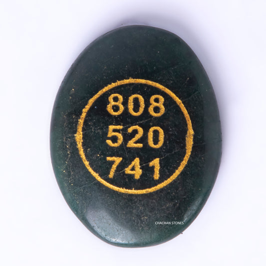 Black stone with gold embossed numbers on a white background