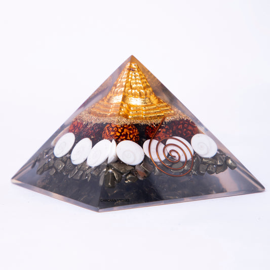 Pyramid-shaped object with stones and a spiral design on a white background