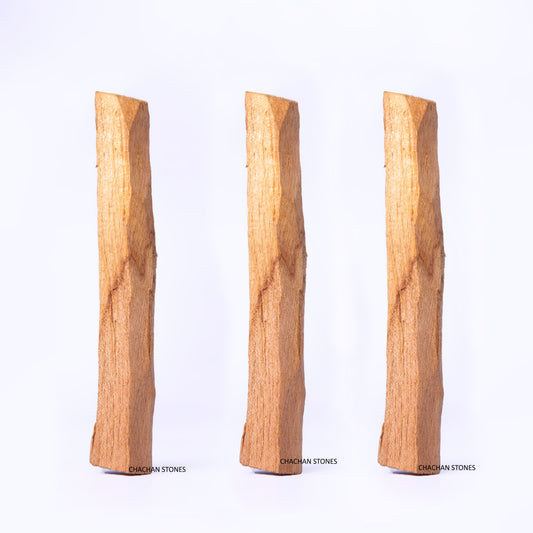Three Palo-santo-wood-stick of different lengths on a white background
