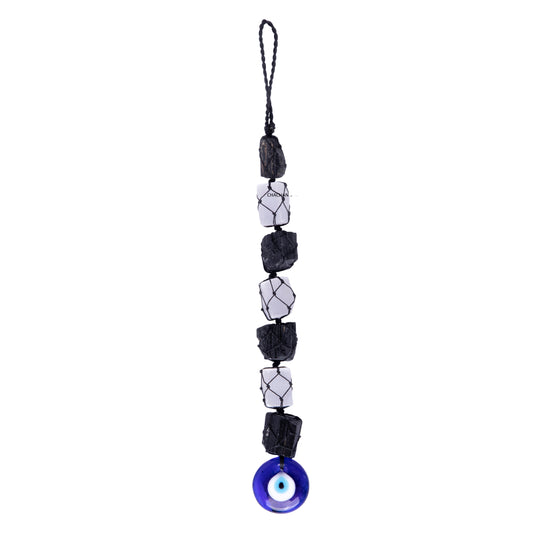 String of black and white beads with a blue evil eye charm on a white background