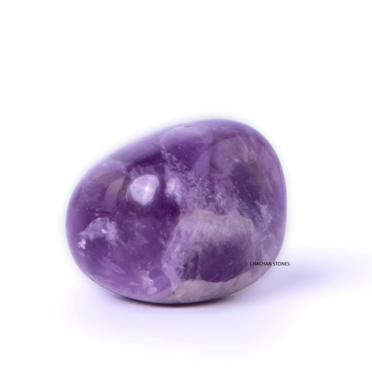 Purple amethyst crystal on a white background