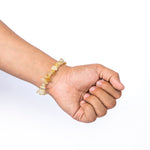Hand wearing a bracelet on a white background