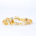Necklace with yellow stone beads on a white background, branded 'Chachan Stones'.