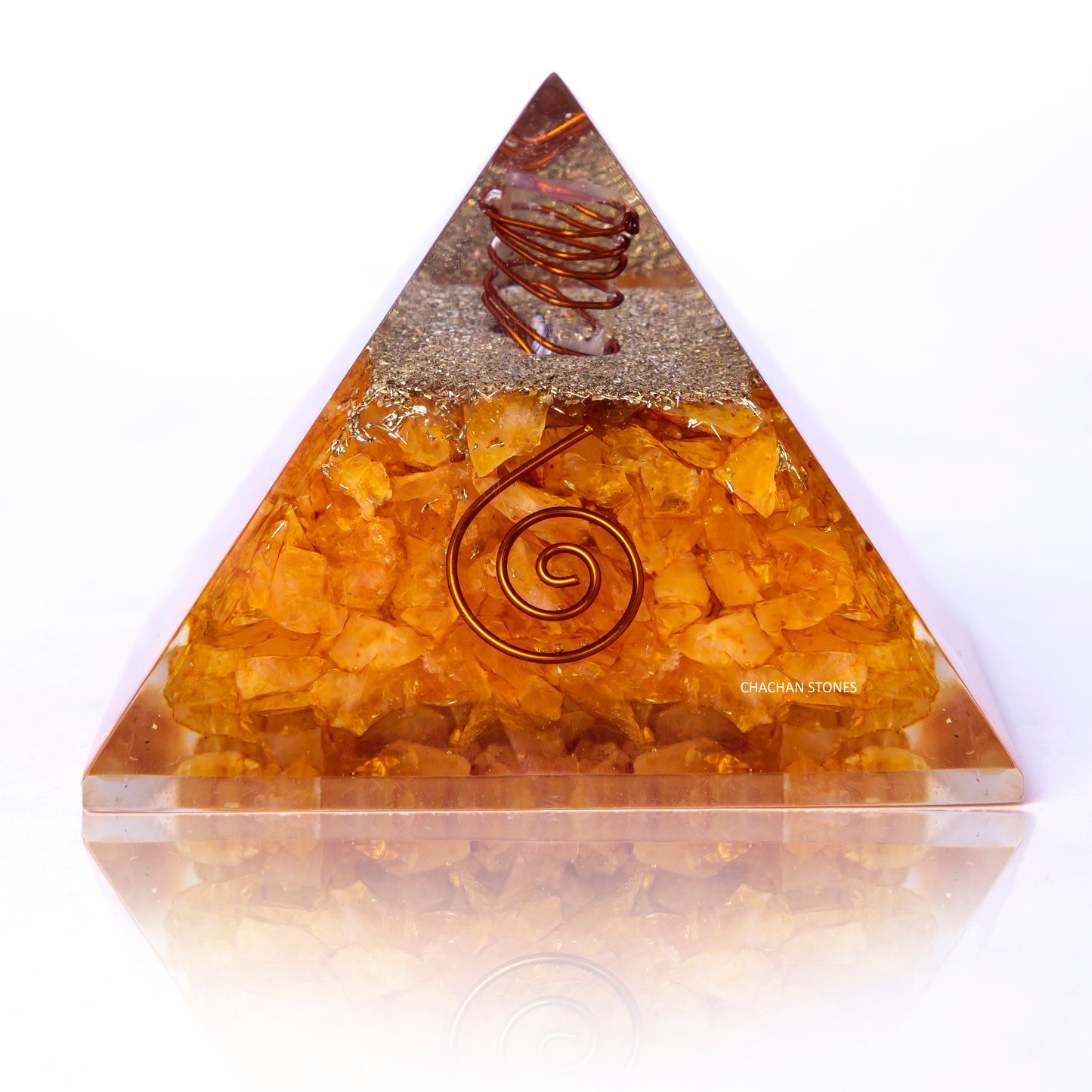 Triangular crystal pyramid with spiral design on a white background