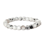 Beaded bracelet with white and black stones on a white background
