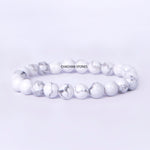 White beaded bracelet with 'Chachan Stones' branding on a light gray background
