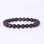 Dark brown beaded bracelet on a white background