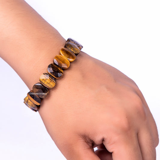Bracelet with tiger eye stones on a wrist against a white background